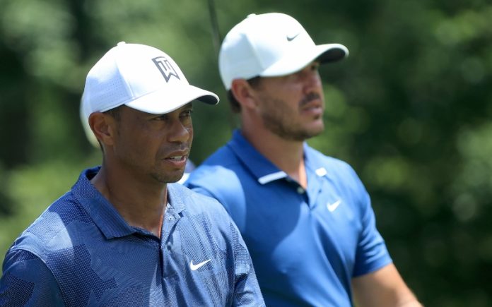 Tiger Woods of the United States and Brooks Koepka of the United States walk from the ninth tee during the second round of The Memorial Tournament on July 17, 2020 at Muirfield Village Golf Club in Dublin, Ohio. (Photo by Sam Greenwood/Getty Images)