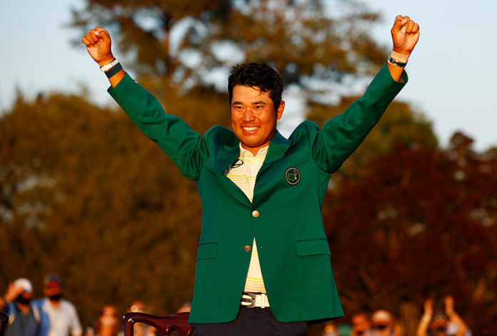 Hideki Matsuyama celebrates with the green jacket after winning The Masters