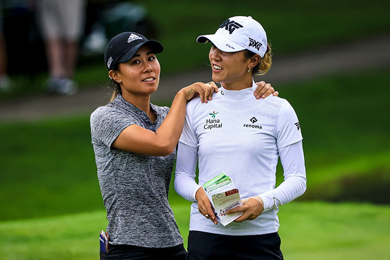 Danielle Kang (L) and Lydia Ko smile after a birdie on the fifth hole during the second round of the Dow Great Lakes Bay Invitational at Midland Country Club in Midland, Michigan. (Photo by Sam Greenwood/Getty Images)